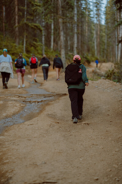 Couples and friends hiking forest trail for Colorado elopement