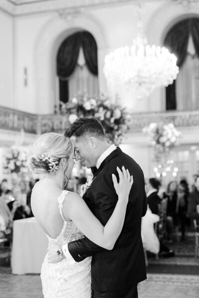 husband and wife wedding photographers capture groom kissing bride on the forehead in Ohio