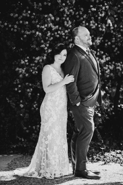 Couple dancing together in a sunlit courtyard during a wedding shoot.
