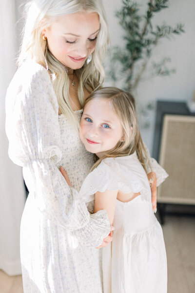 Image of little girl hugging her mother in home taken by Family Photographer Sacramento Kelsey Krall