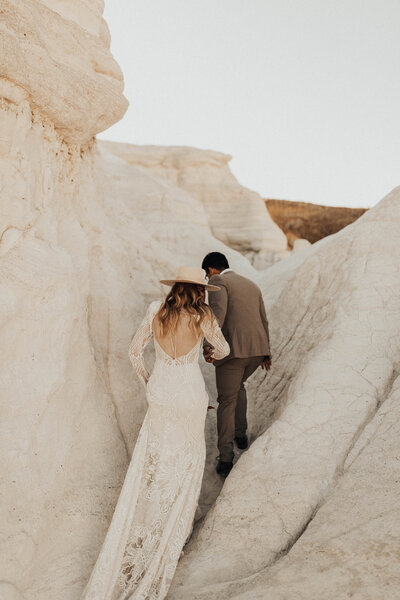 Bride and groom wandering through canyon