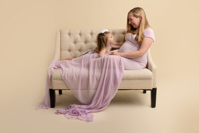 mom and toddler on couch by Philadelphia Newborn Photographer