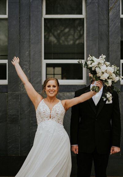 Spring wedding in downtown Iowa City with a Beno's Flowers bouquet