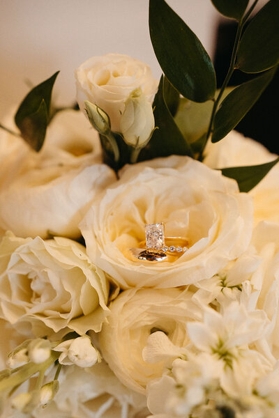 An engagement ring in the middle of a floral bouquet 
