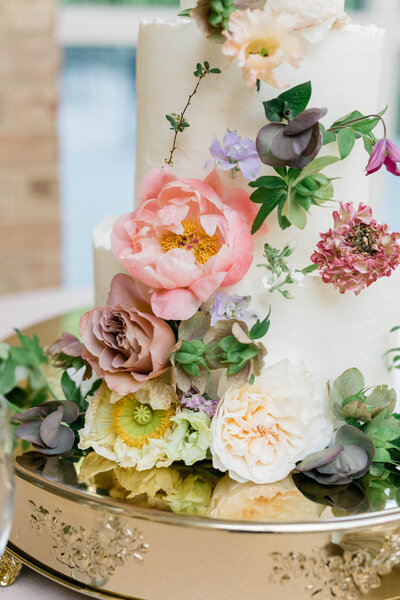 A classic wedding invitation suite with greenery, white, and ivory florals.
