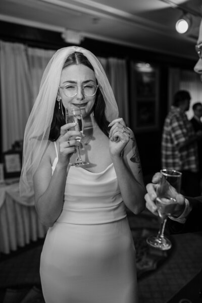 bride giving a funny look while drinking champagne