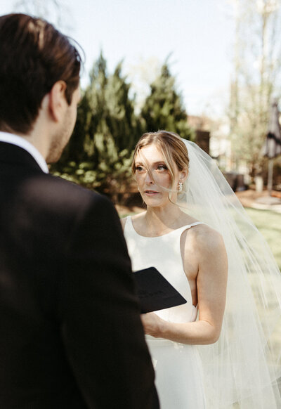 couple holding hands and looking at one another