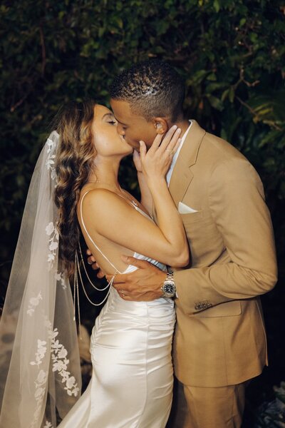bride and groom share a kiss after wedding ceremony