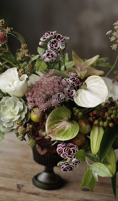 Statement floral arrangement placed in a home foyer for a subscription client.