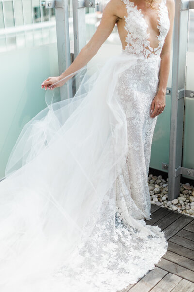 Beautiful photos of a bride in her wedding dress on the balcony of a hotel.