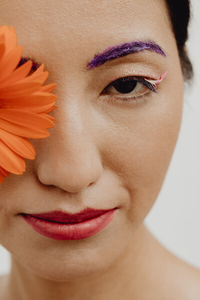 kaboompics_sensual-portrait-of-a-asian-woman-with-flowers-on-her-face-21964