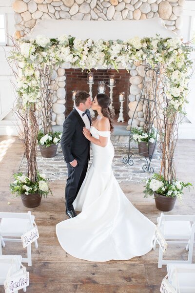 Romantic indoor wedding ceremony at Bonnet Island Estate in New Jersey, captured by a luxury wedding photographer.