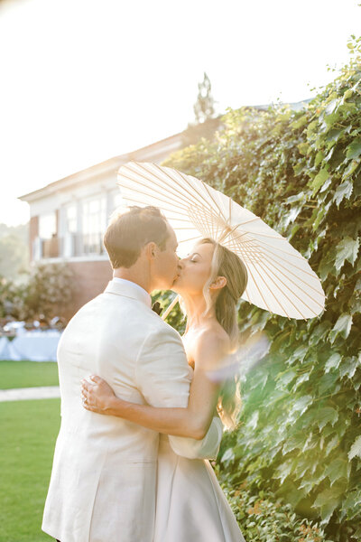 Bride and groom holding hands at their outdoor ceremony