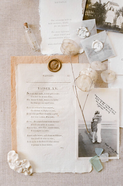 a wedding poem flatlay with old family photos and flower seed packets