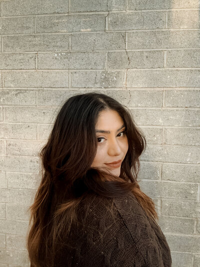 Self-portrait of Silvia, a luxury portrait and event photographer, in soft natural light.