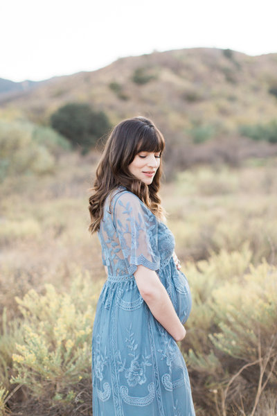 Maternity photographer in Denver, pregnant mother holding her belly 
