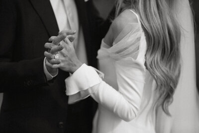 bride and groom holding hands