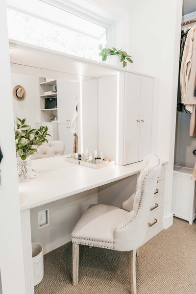 A neatly organized vanity within a primary closet