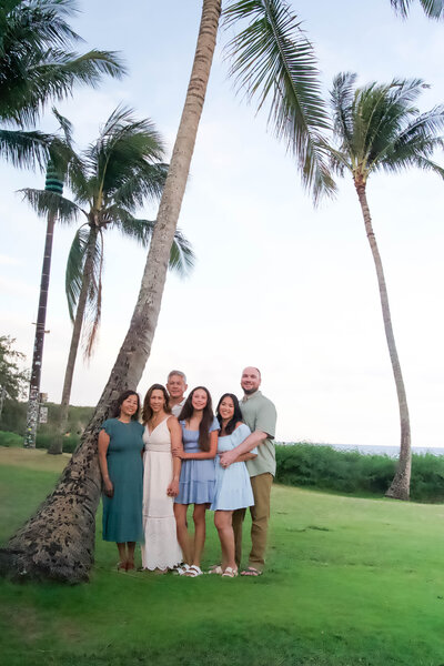 Multi-generational family photo in the golden sunset on Shipwreck Beach in Kauai, Hawaii