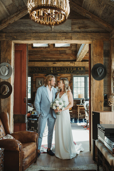 Greenhouse wedding Bride and groom embracing in a greenhouse at stone post key in middletown ct groom kissing neck of bride and bride looks up with closed eyes tropical plants and soft light surround them Love Jackie Wedding CT Wedding Photographer