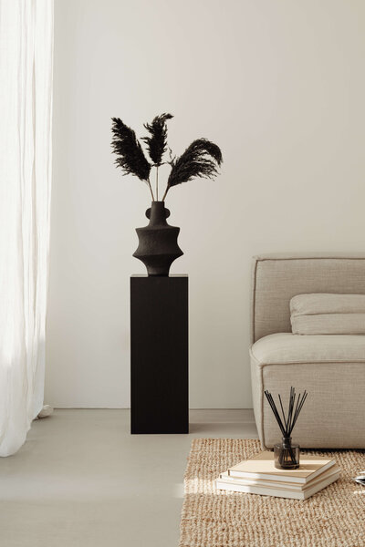 Dramatic black vase on pedestal at Vancouver penthouse interior design project