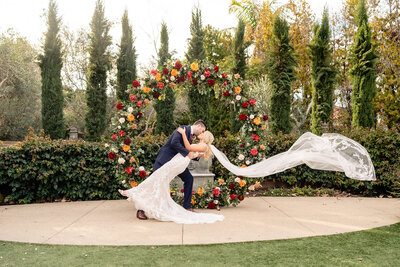 Bride and Groom walking down walkway and laughing at their wedding at Estancia Hotel and Spa wedding venue