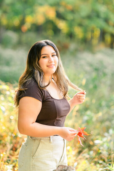 Latina high school senior girl twirling her hair by Chicago Senior Photographer Kristen Hazelton