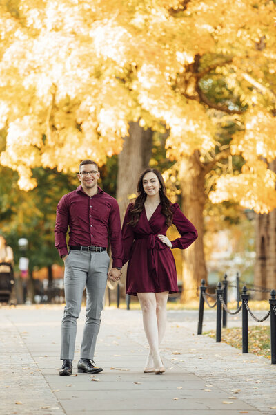 Princeton University | Couple posing for pre-wedding photo among yellow trees | Princeton, New Jersey