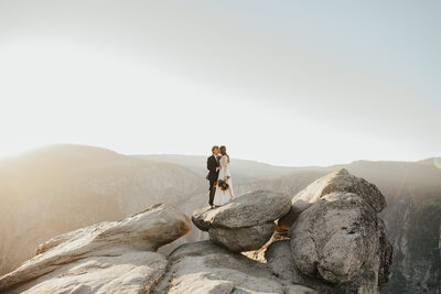 couple kissing on rock in yosemite national park