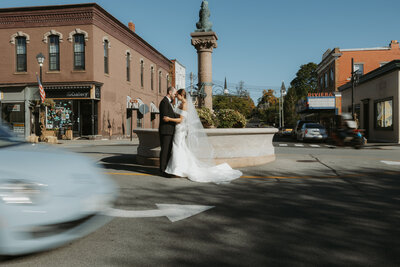 Bride and Groom in front of the fountain in down-town Geneseo, NY. Photo by Dash and Boheme Photography