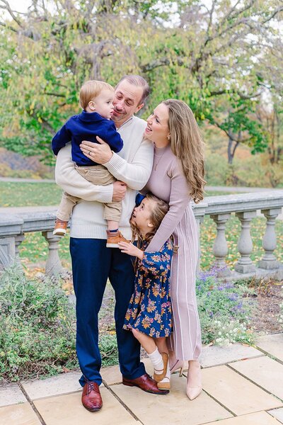Pittsburgh Family Photographer taking a picture of a sweet family at Hartwood Acres.  everyone is hugging and looking at baby boy.