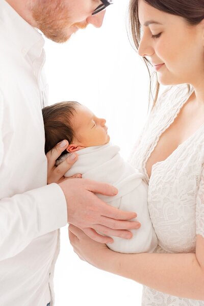parents holding newborn baby taken by Newborn photographer Boston in photography studio Massachusetts