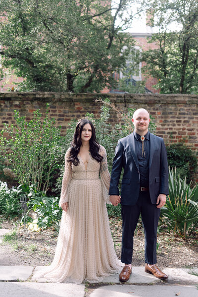 Bride and groom in edgy wedding attire outside the Quirk Hotel in Richmond, Virginia, captured in a rock ‘n’ roll editorial style by Editorial Wedding Co.