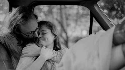 black and white couples photo in a car
