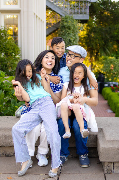 Family of five laughing and snuggling on stone steps in a garden — Bay Area Photographer Services - Ellobelle Photography Family Photographer