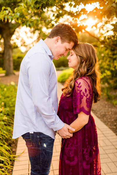Bride with flower crown and groom nuzzling her forehead