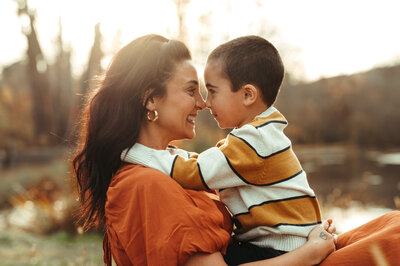 A mother and her son look deeply into each others eyes and smile. 