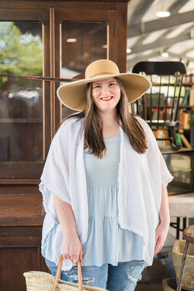 Lauren explores a flea market in wide brimmed straw hat