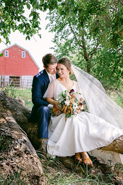 Bride and groom outside barn for family farm wedding in Hillsboro, ND
