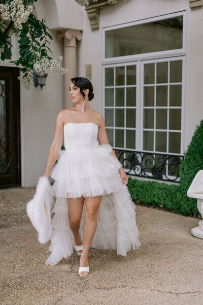 Wedding Photographer, a bride and groom stand together at the bottom of a staircase