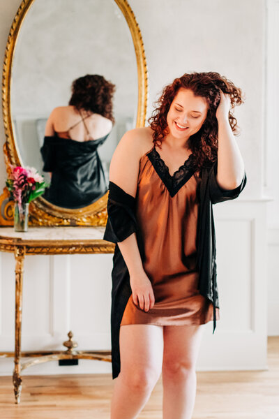 Missoula boudoir woman wearing satin robe and nightgown