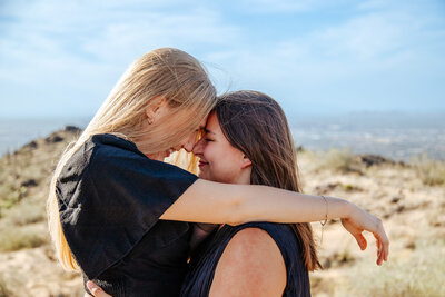 gay women embracing at proposal
