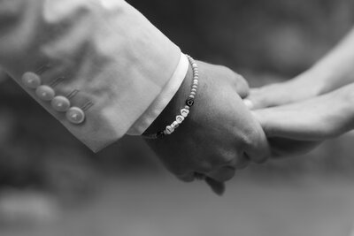 Groom holding bride's hands