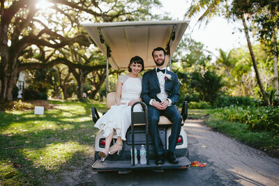 Bride and Groom in Golf Cart on Wedding Day