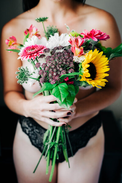 Boudoir photo Missoula woman holding flower bouquet