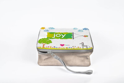 Luua zippered lunchbox with the word colorfully written "JOY" on top of it.