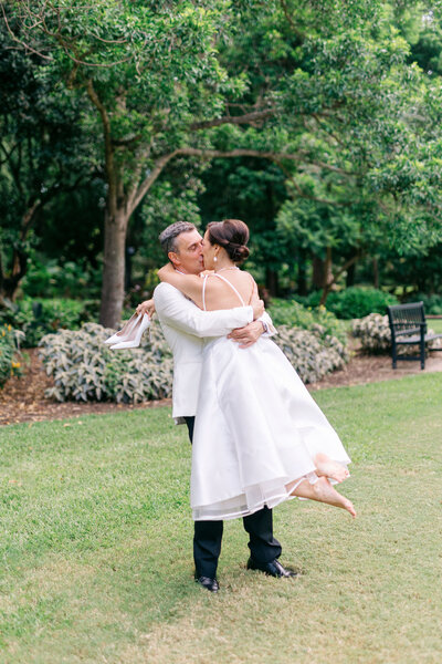 Newlyweds walking through the Brisbane City Botanic Gardens — natural, romantic outdoor wedding photography in the heart of Brisbane.
