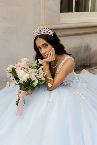 woman wearing a crown and dress standing with her eyes closed