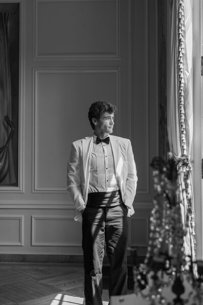 Groom getting ready in suit in Newport mansion