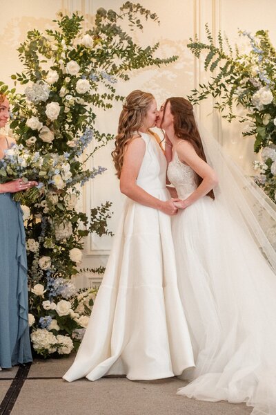 Romantic floral details with blush roses and greenery by Leigh Florist, complementing an elegant wedding ceremony design.